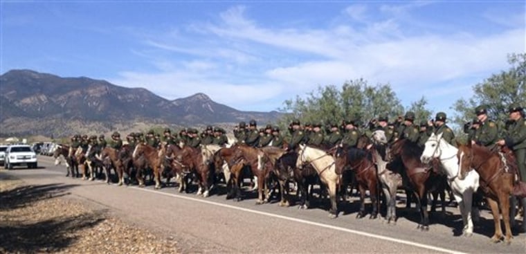 Mounted officers line the route during the funeral procession for slain U.S. Border Patrol agent Nicholas Ivie on Monday, Oct. 8, at the Church of Jesus Christ of Latter Day Saints in Sierra Vista, Ariz. 